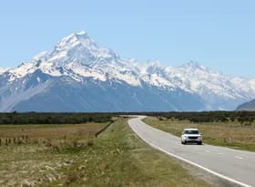 Car on road with Mount Cook in the background