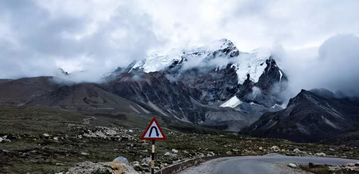 Road Curve in Front of Snowy Mountain